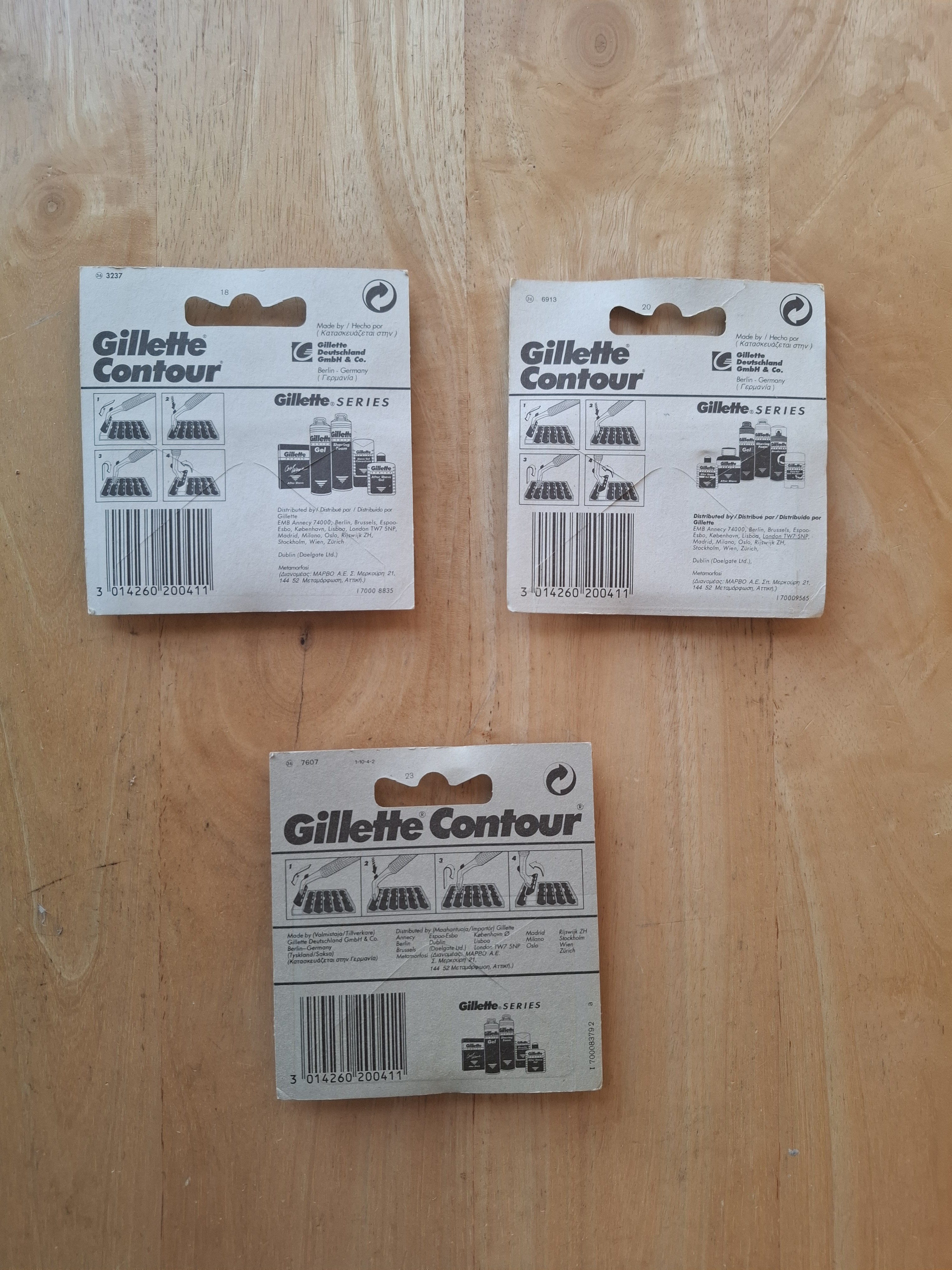 Three Gillette Contour card backs, showing barcode, batch code and distributor print variants