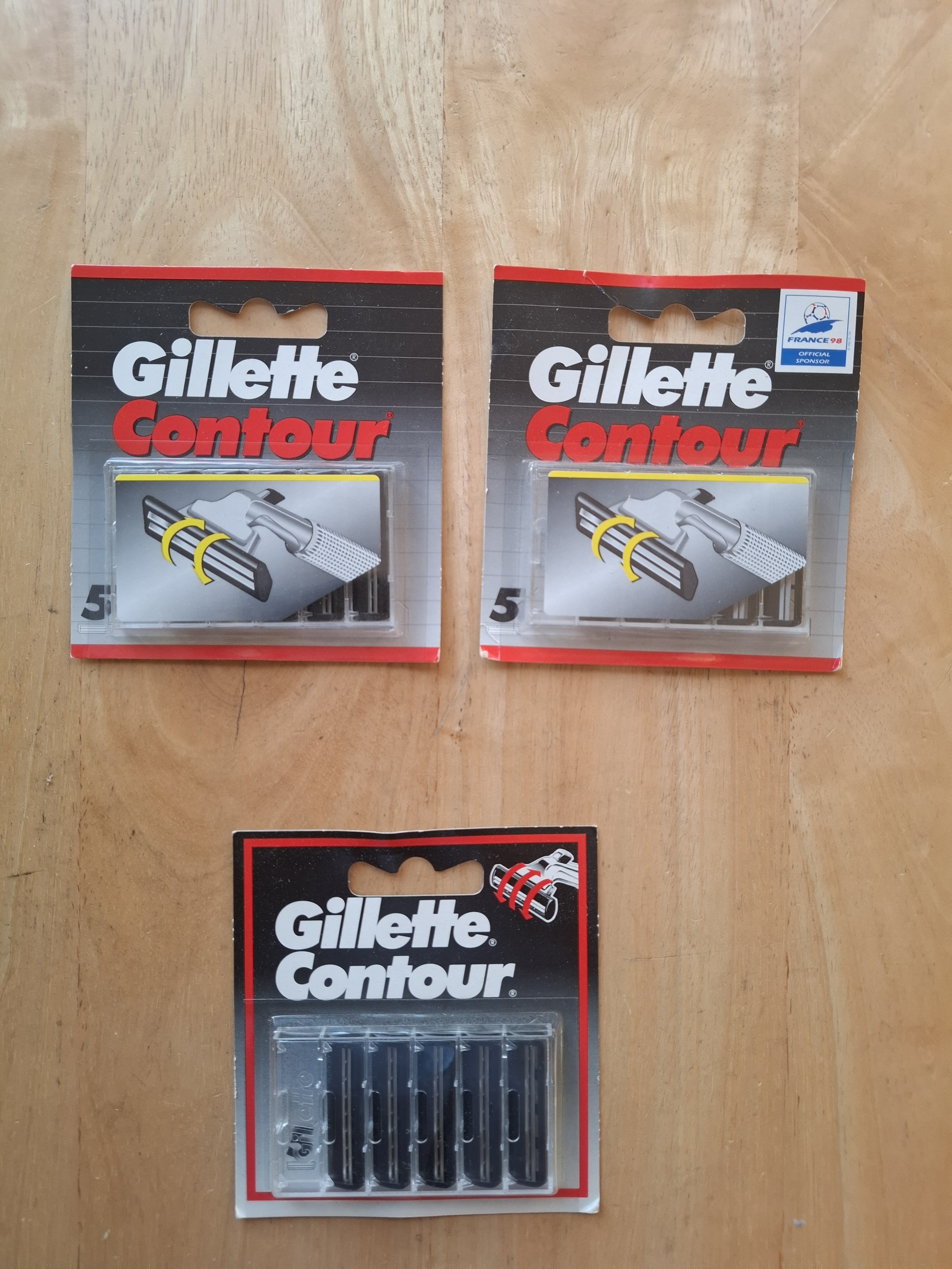Three Gillette Contour card fronts: two in grey/red current livery, one in an older black/red design