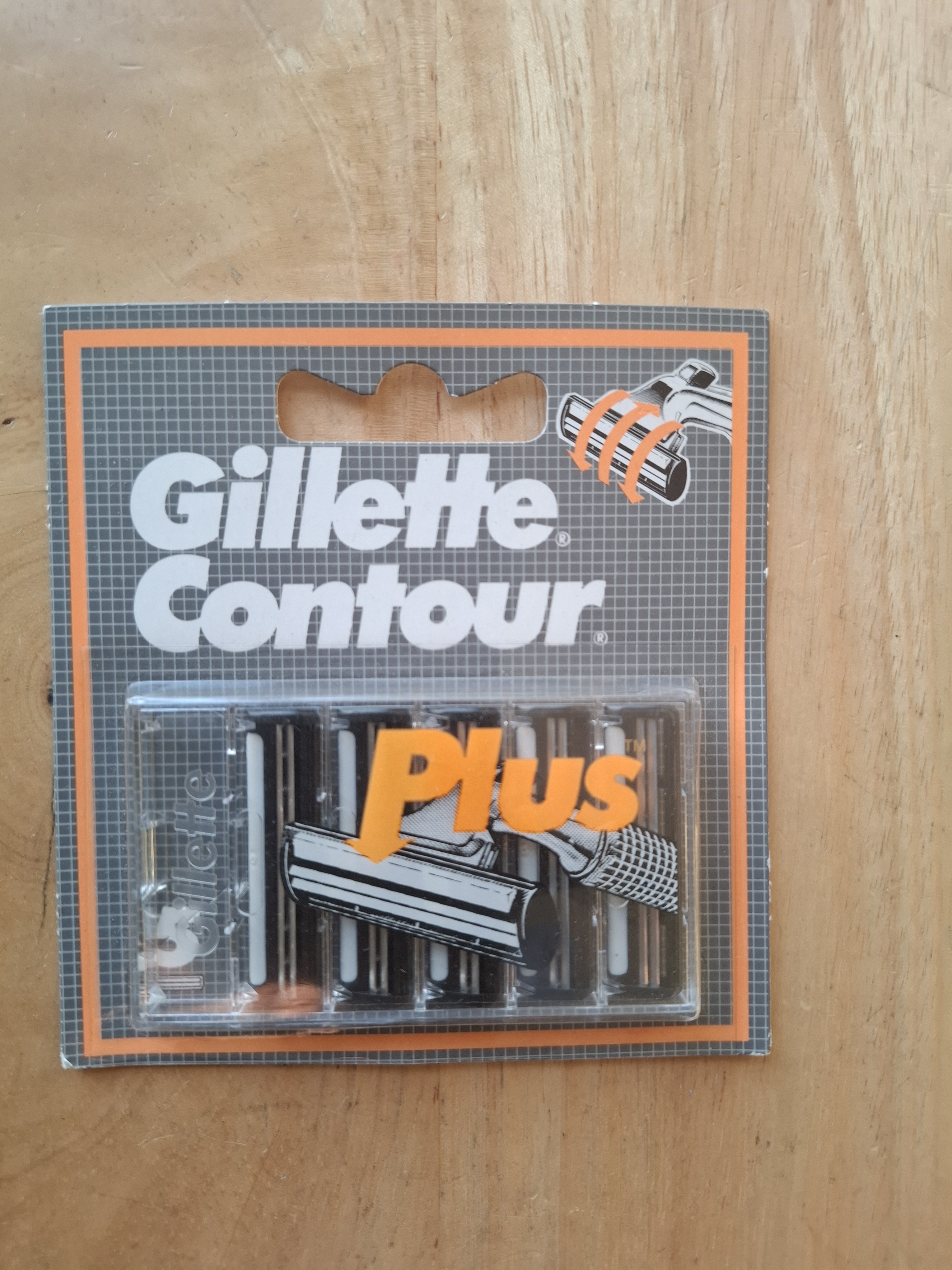 Gillette Contour Plus card front, showing grey grid livery, orange arrow graphic into the blades and pivot-motion icon