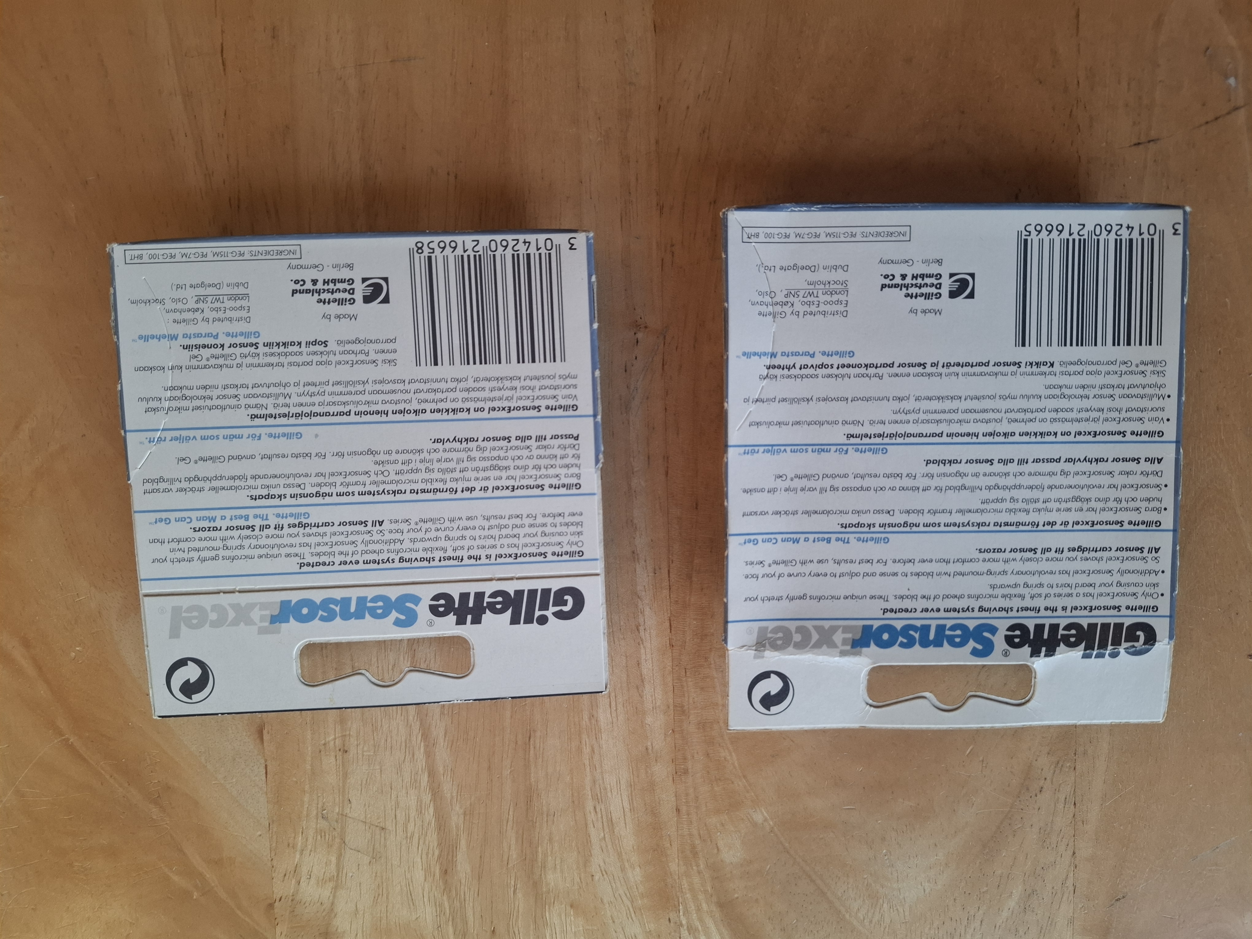 Two Gillette Sensor Excel carton backs, showing marketing copy in three languages, barcode and distributor list